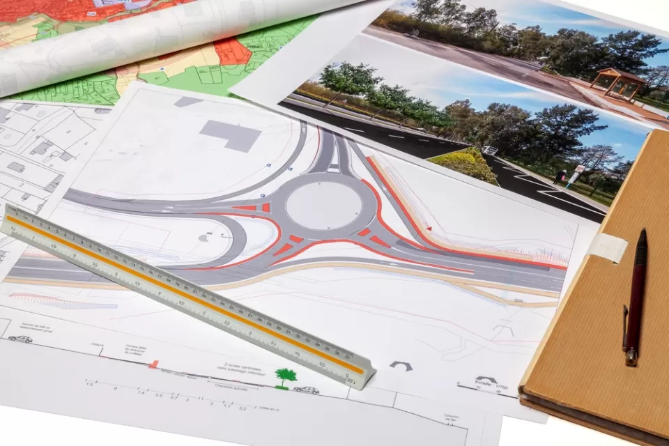 Diagram of a roundabout and site photos laid out on a desk